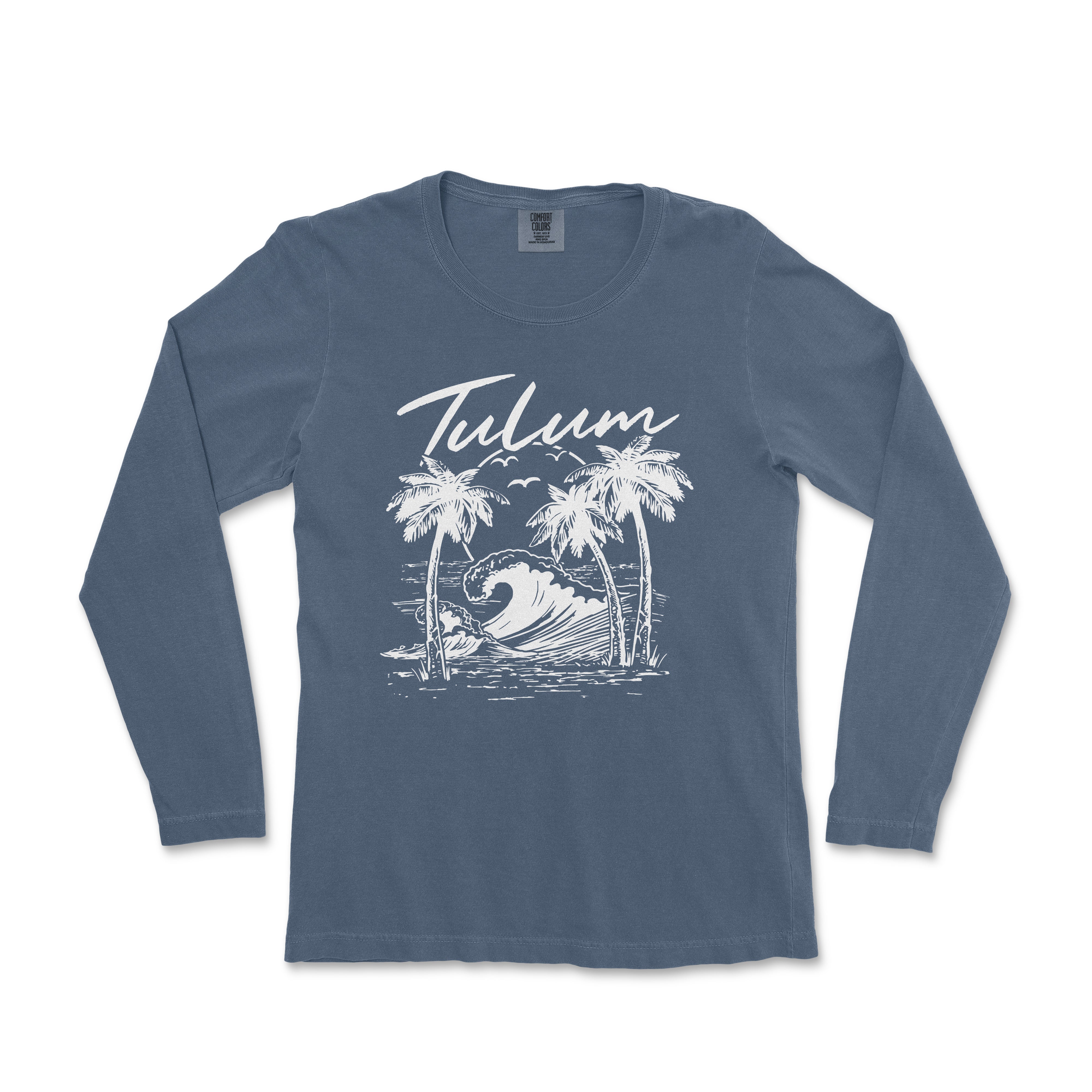 a women's long sleeve shirt with a graphic of a surfer riding a wave