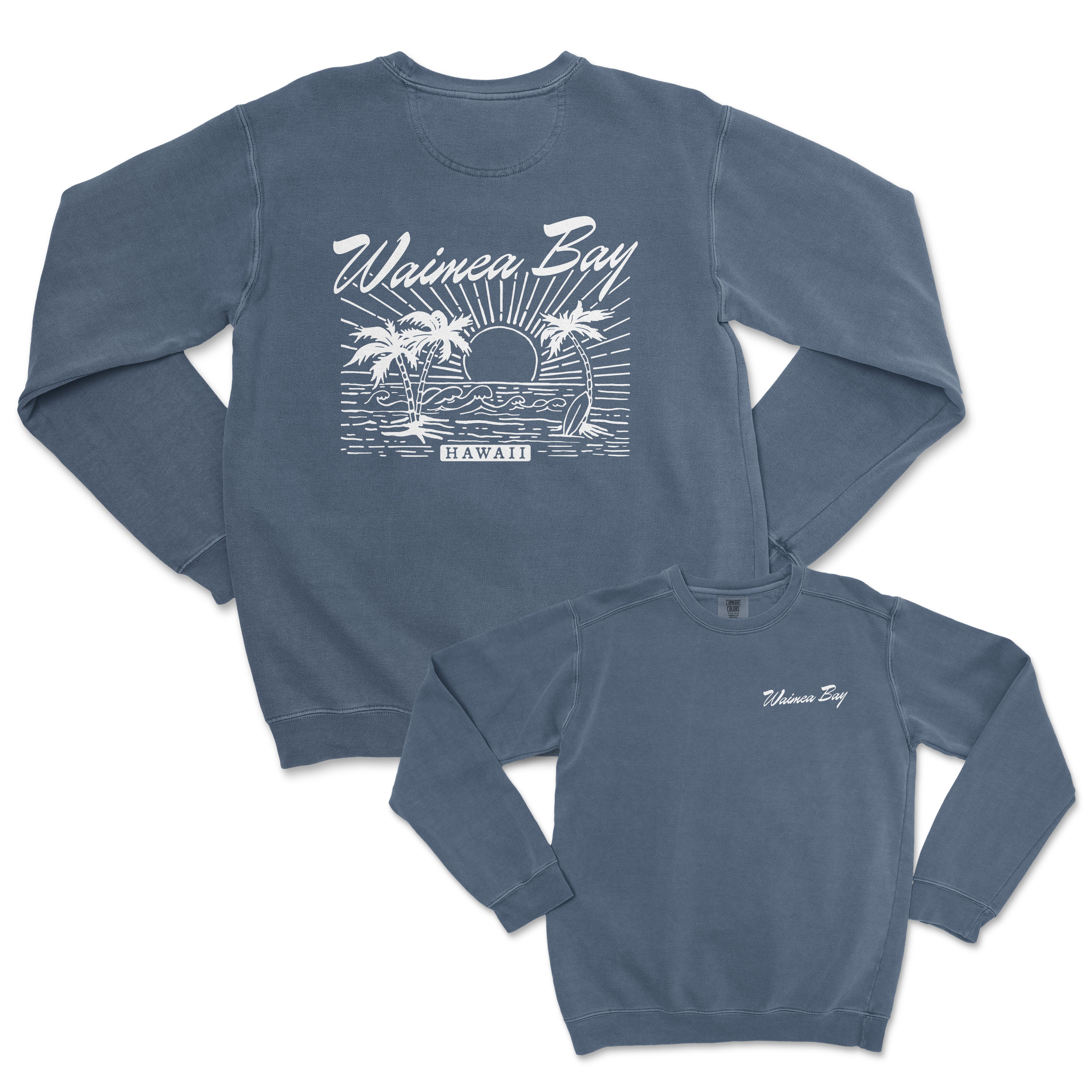 a blue sweatshirt with a picture of a sunset and palm trees